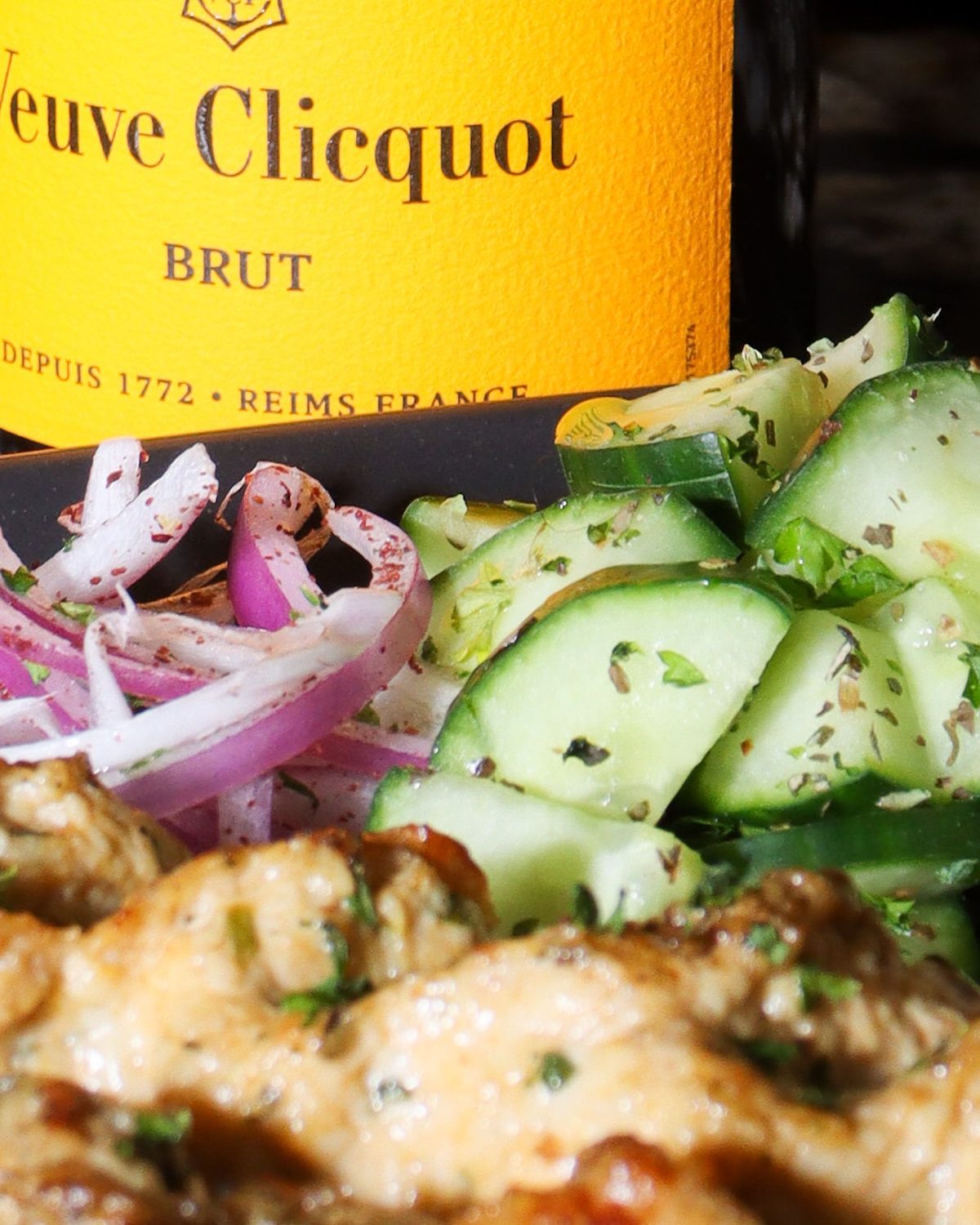 Champagne and a chicken kabob plate on the bar