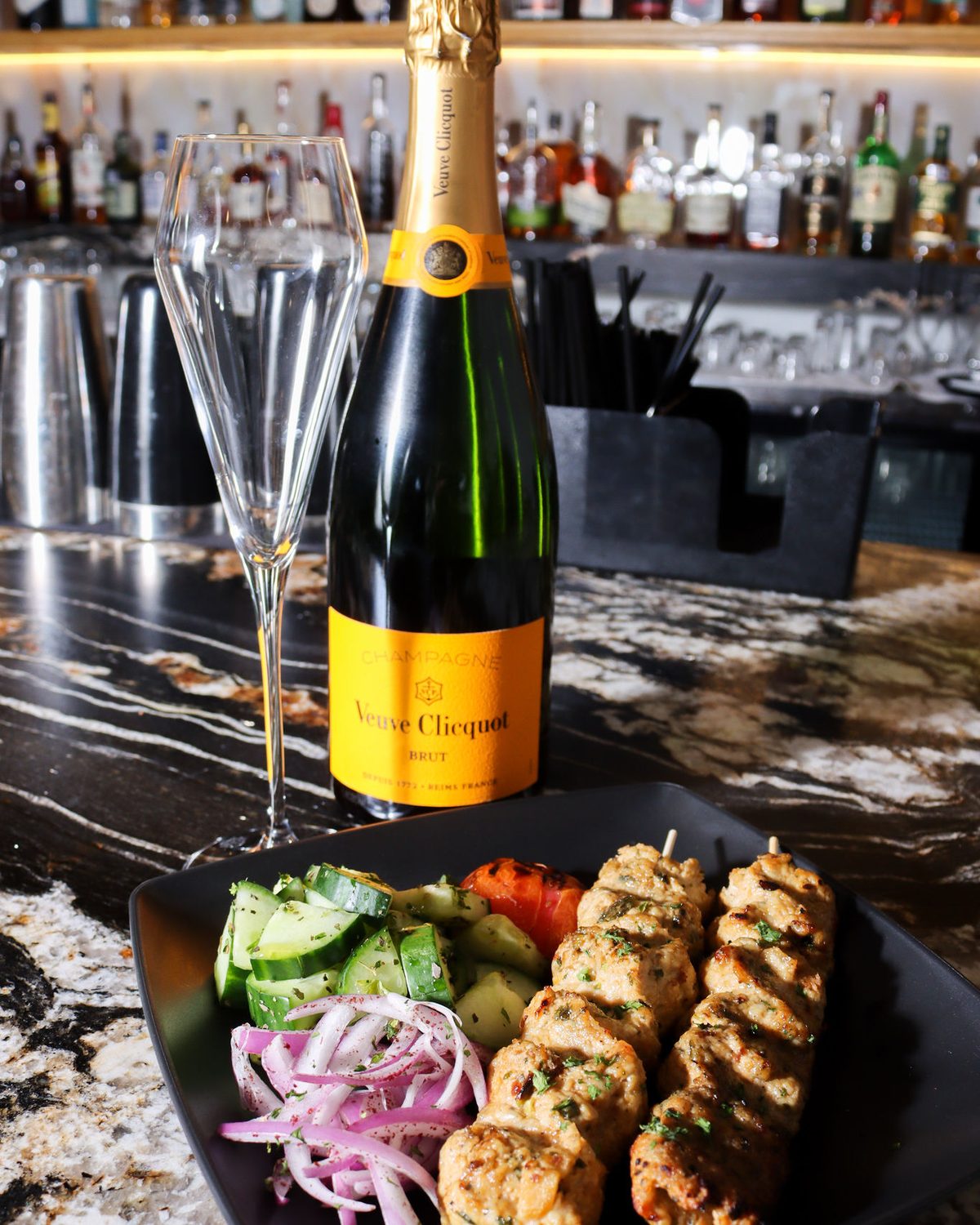 Champagne on ice against the backbar bottles
