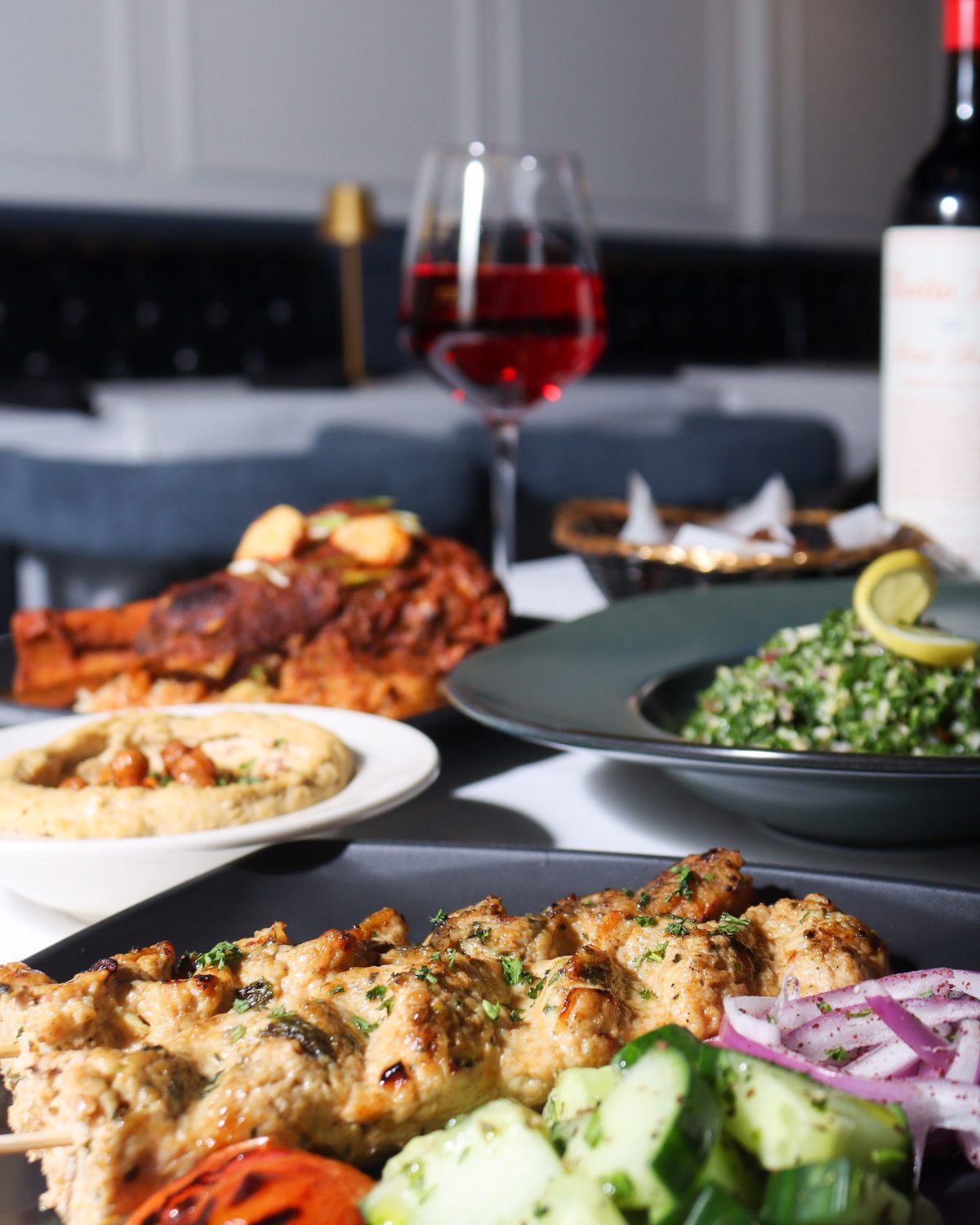 Wine and dinner laid out across a corner table