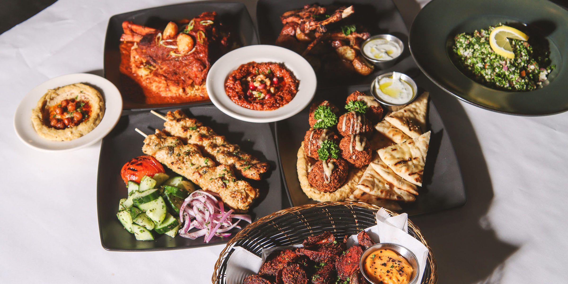 A long table laid with mezze, kabobs and wine in the Fusion dining room