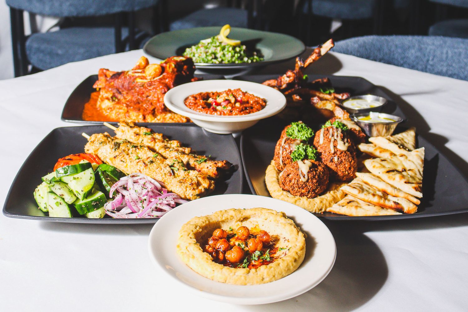 Kabobs, mezze and salad plated for delivery