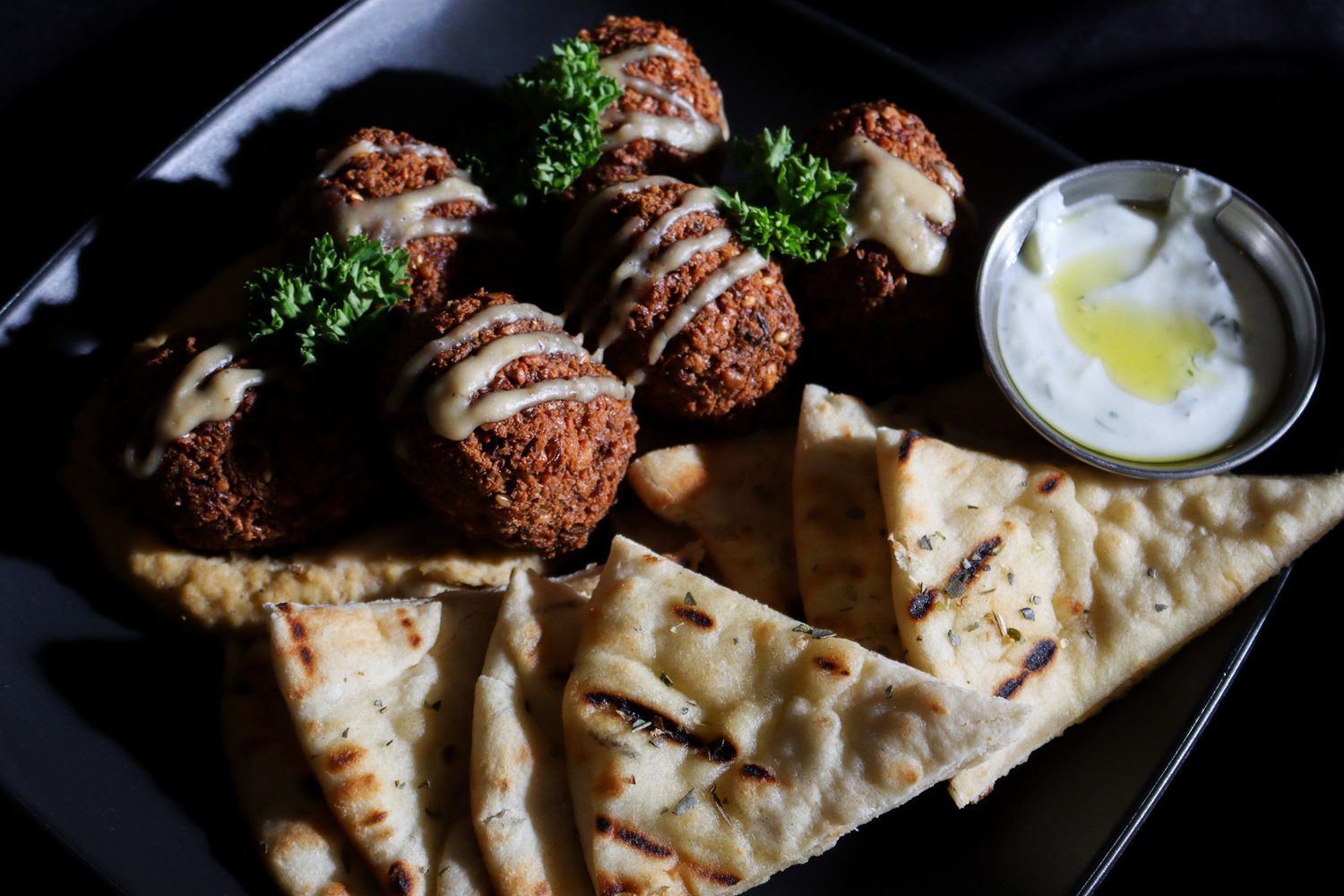 A falafel platter boxed for pickup